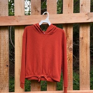 A red-ish brown light hoodie size kids large